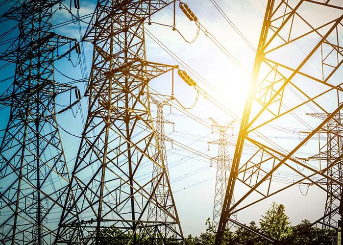 High-voltage electricity transmission pylons at sunset